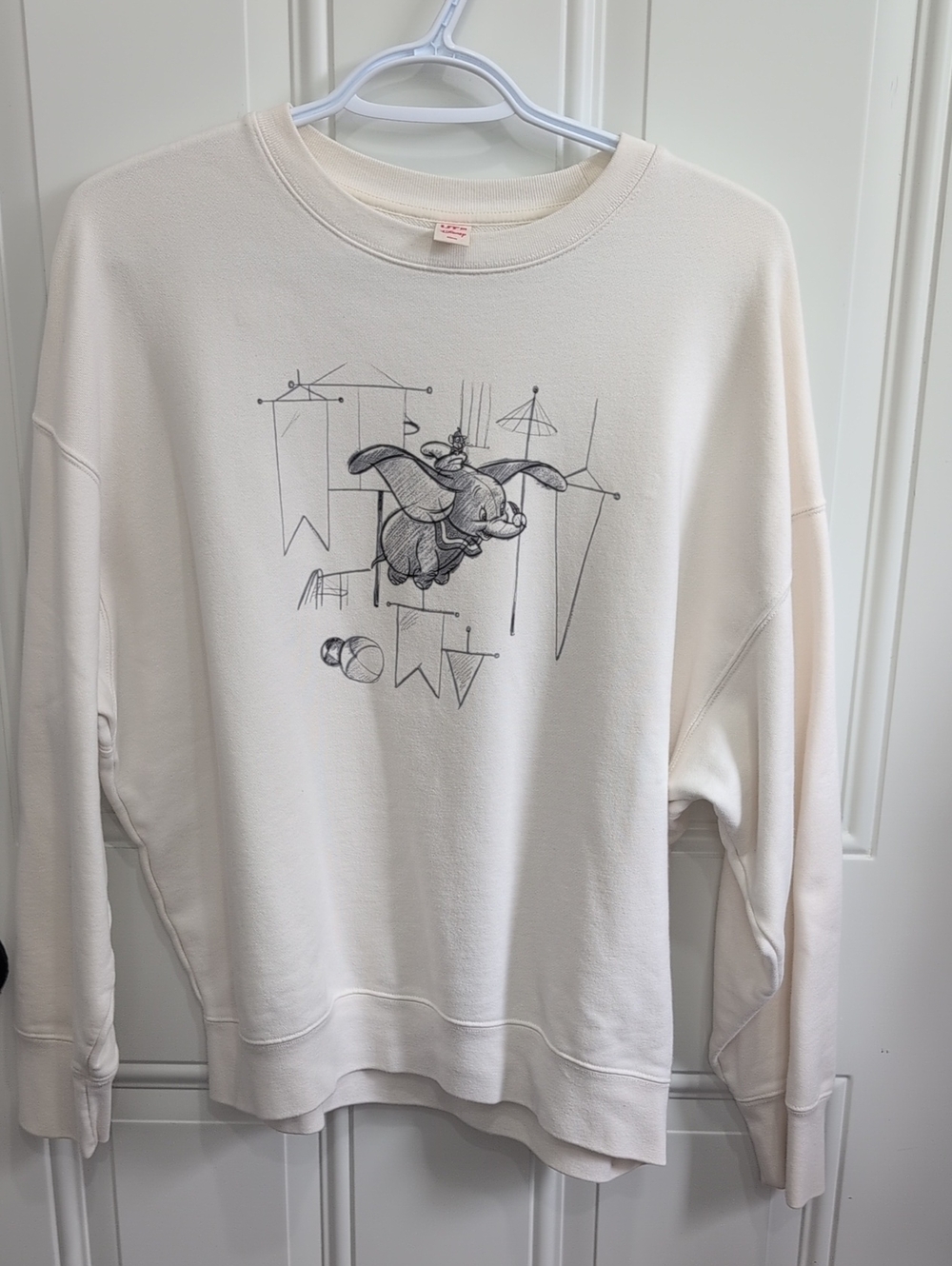 Uniqlo x Disney sketchbook sweatshirt features a graphic of Dumbo and Timothy